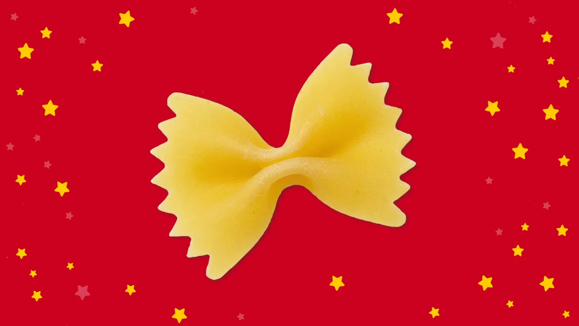 Nudelquiz: einzelne Farfalle vor rotem Hintergrund mit gelben Sternen