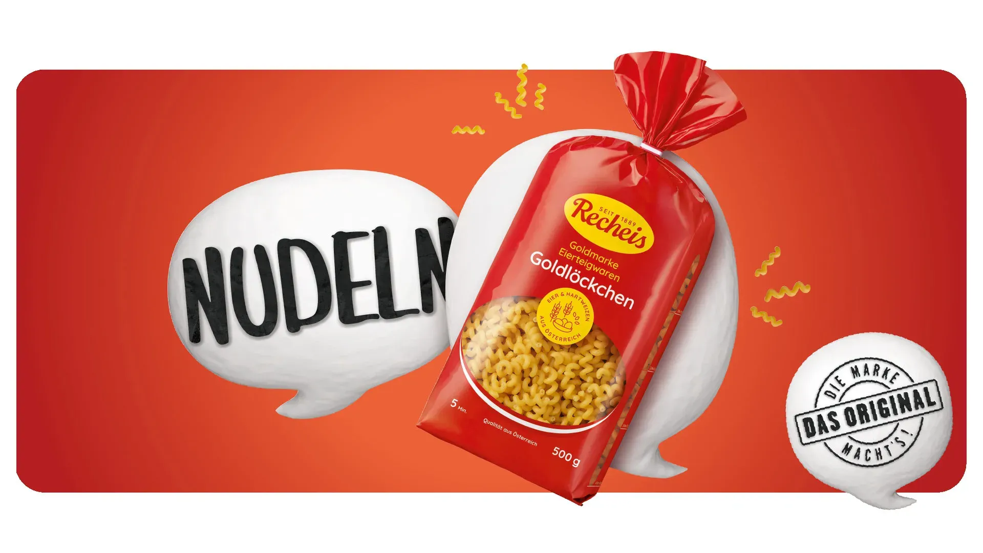 Packung Recheis Goldlöckchen Nudeln vor orangem Hintergrund mit Sprechblasen
