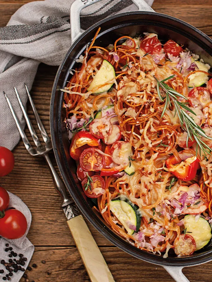 Spaghetti al Forno mit cremigem Gemüse und Ricotta gratiniert (Pasta di Peppino) in schwarzem Topf auf Holztisch
